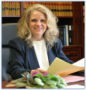 Photo of Judge Martha Geer sitting at her desk in her office